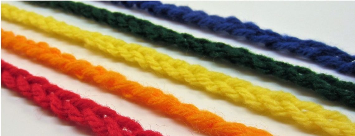 Five crocheted chains in colors of the rainbow