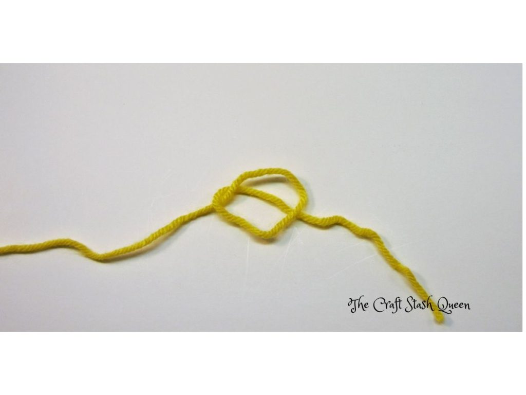 Tail of yarn under loop.