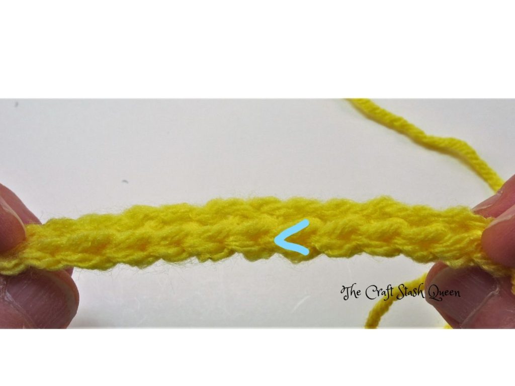 Top of a single crochet row showing the v shape of the top of the stitch.