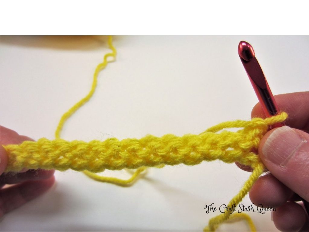 Backside of one row of single crochet in yellow yarn. 
